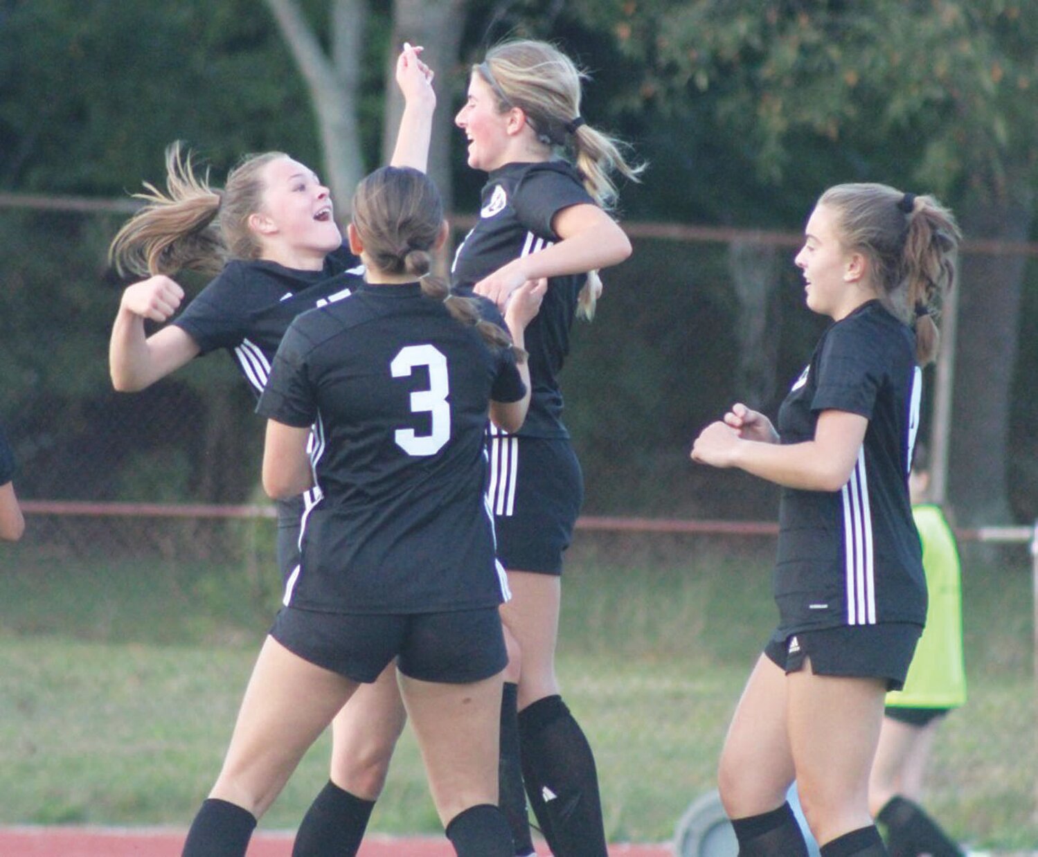 BIG WIN: Members of the Pilgrim girls soccer team celebrate after scoring a goal. (Photos by Alex Sponseller)