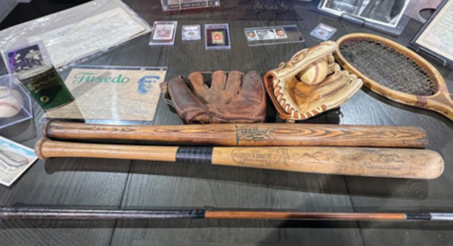 ON THE SHELF: Various collectible items at the Cranston Card Show feature bats, wooden golf clubs, tennis rackets, boxing autographs, gloves, scorecards, advertising, postcards, and tobacco cards.