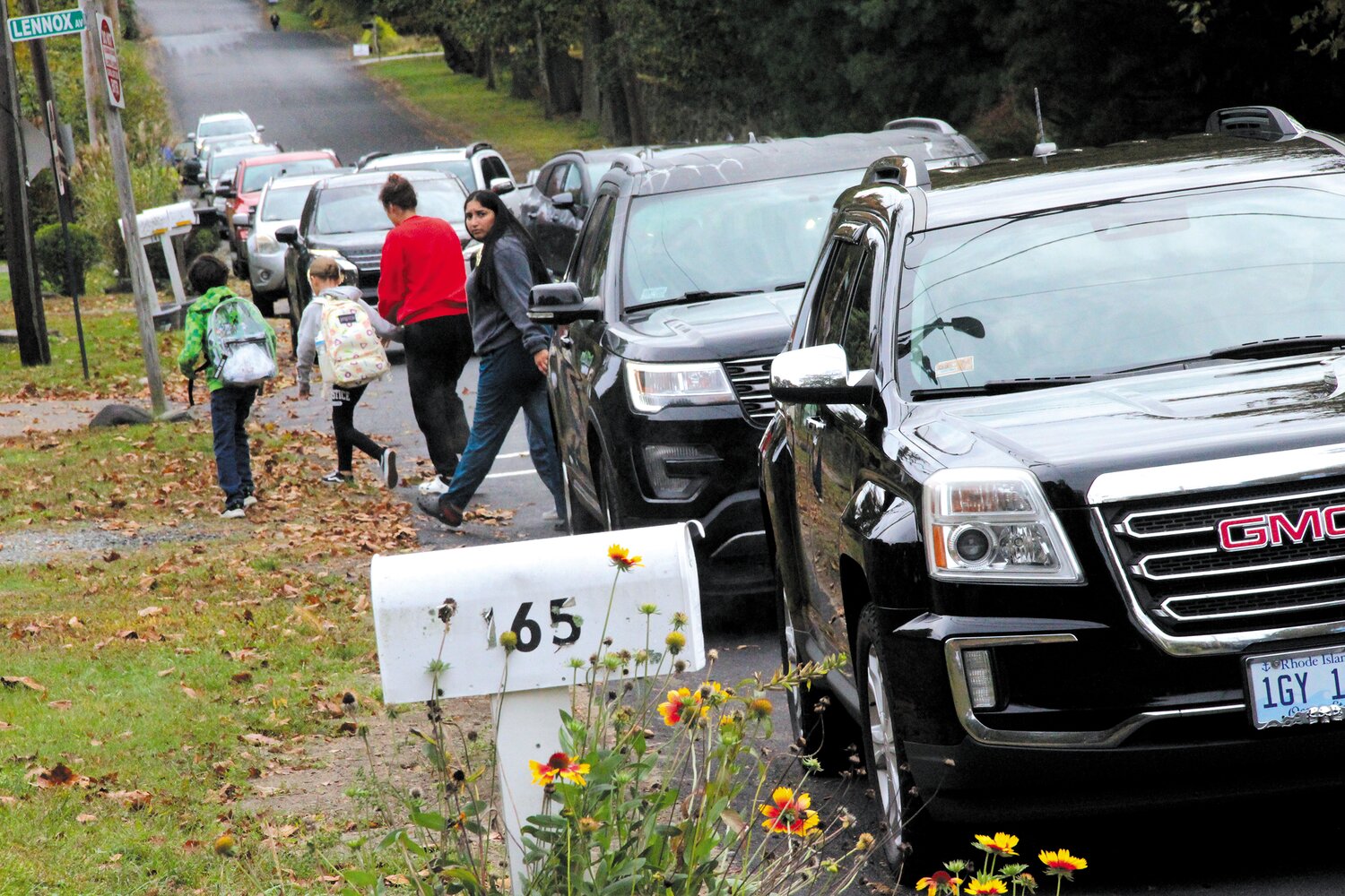 NAVIGATING TRAFFIC: Adults and students cut between traffic on Rocky Point Avenue to get to Warwick Neck School.  (Warwick Beacon photos)